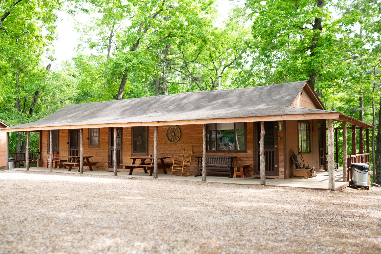 View of Cabin 1 at Sunset Point Resort surrounded by trees and lake